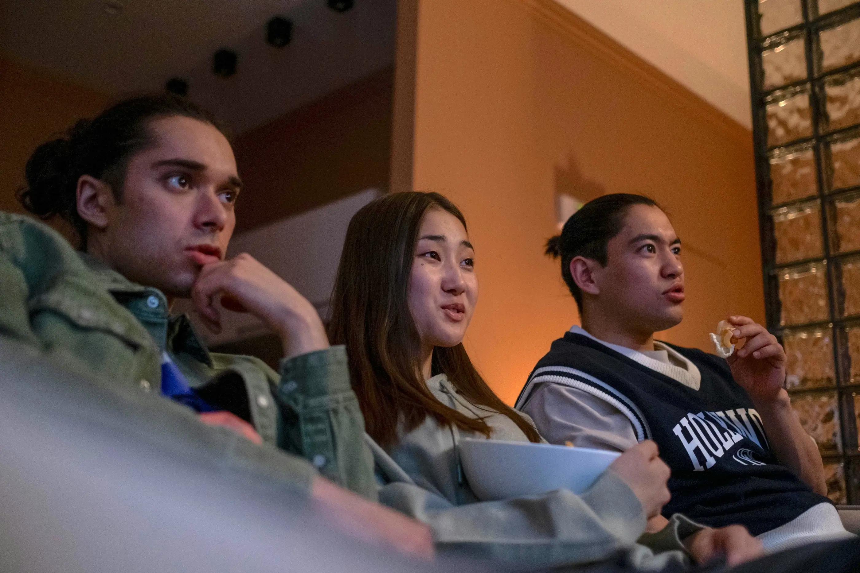 Friends watching TV together on a couch